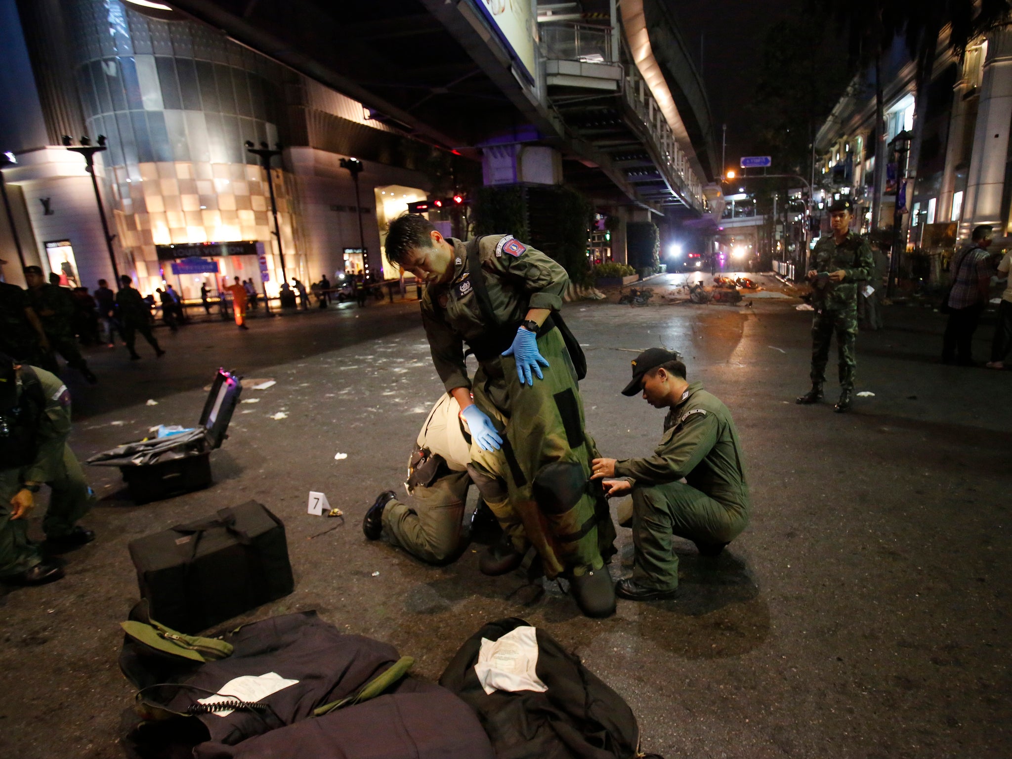 An Explosive Ordnance Disposal team suits up in the middle of an intersection -