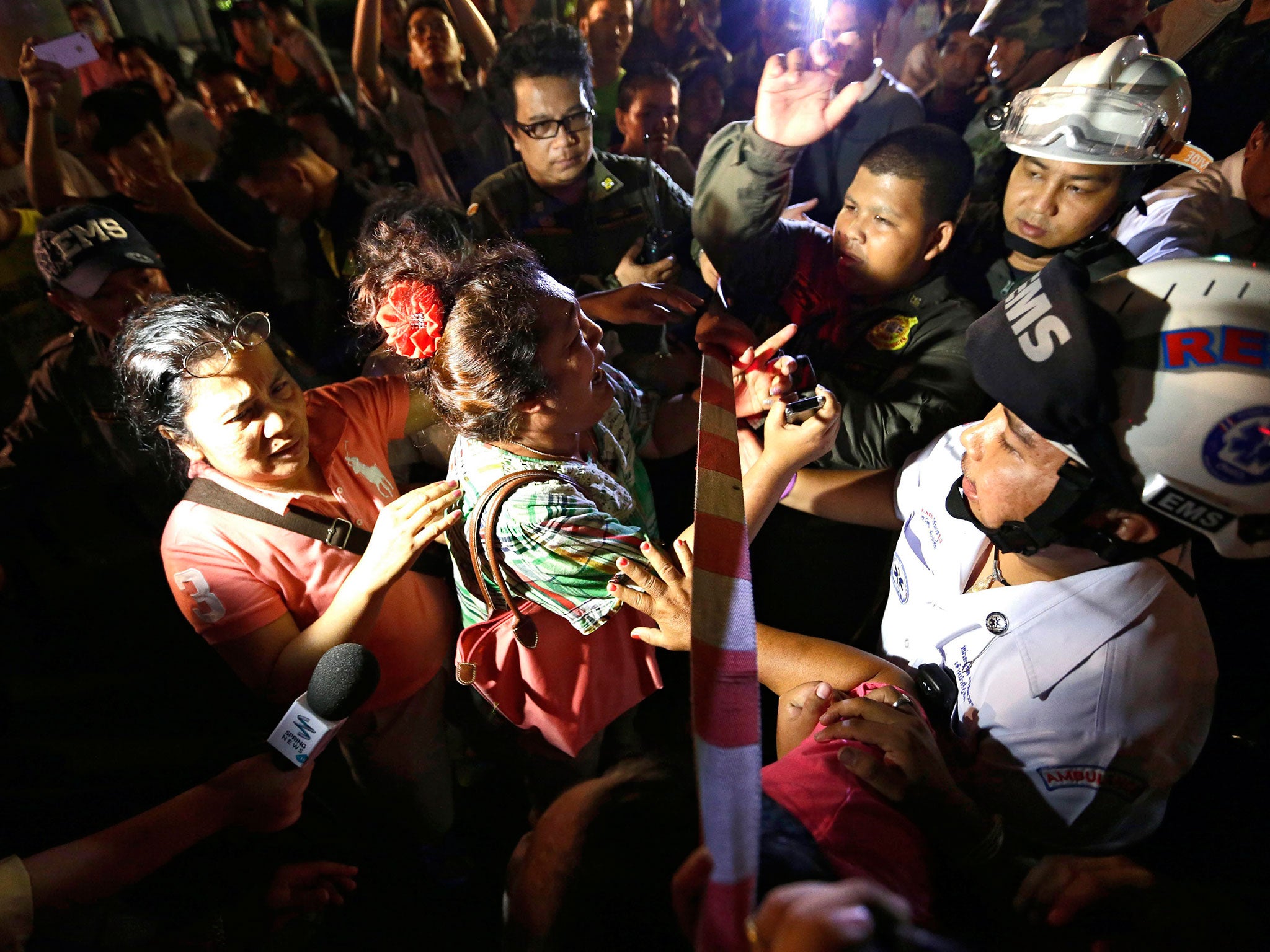 People search for missing relatives near Erawan Shrine after the explosion in the Thai capital