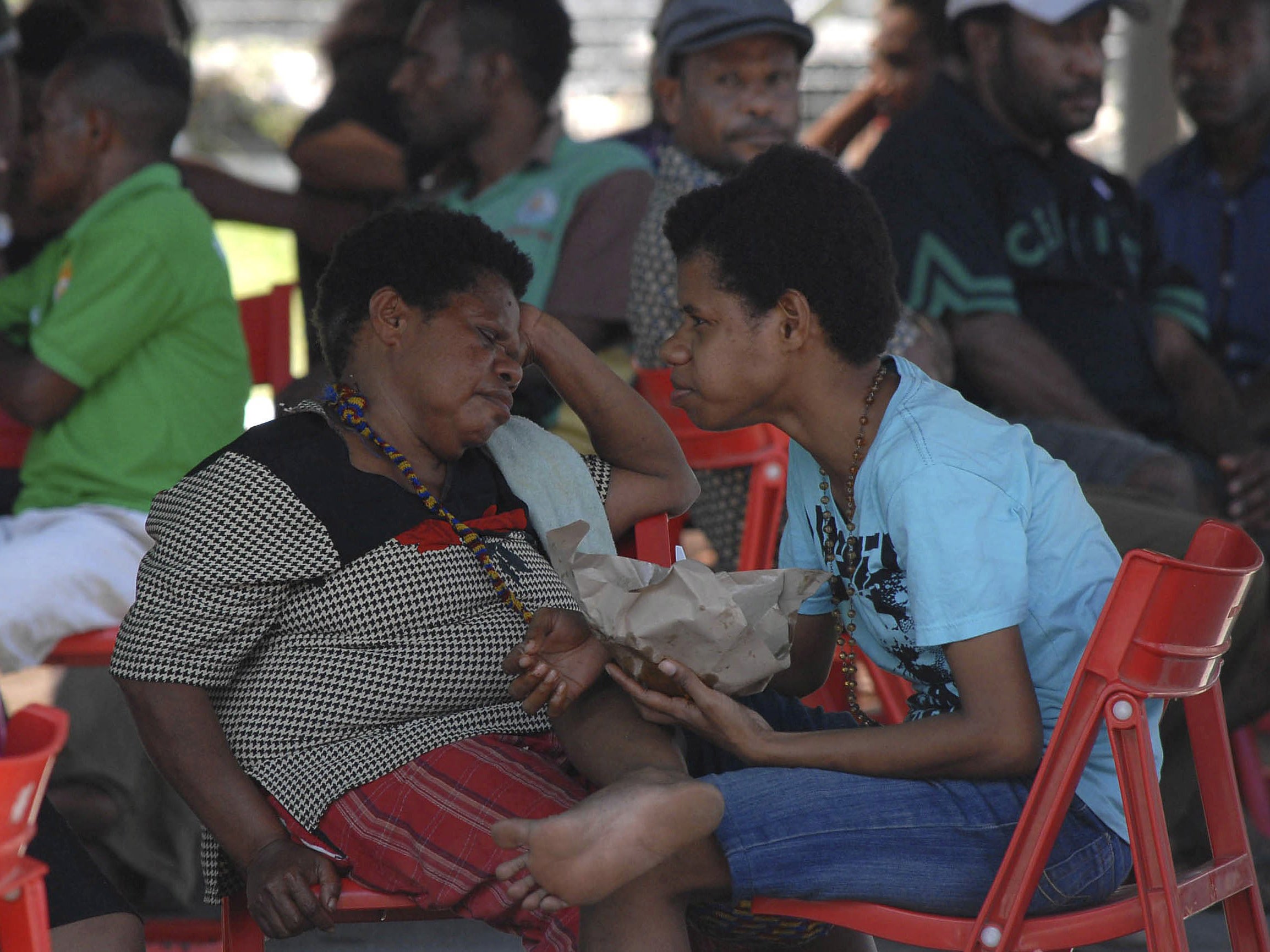 Family members of passengers on board the crashed Trigana Air flight wait for information at Sentani Airport near Jayapura