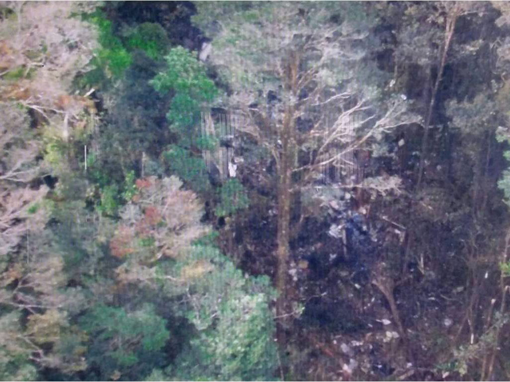 A screen grab of a handout photograph released by Indonesia's National Search and Rescue Agency (Basarnas) shows what is believed to be the site of Sunday's crash  in the heavily forested Bintang Mountains district.