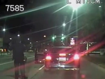 Police dashcam footage captures the moment a baby is delivered in a car after being pulled over for running a red light