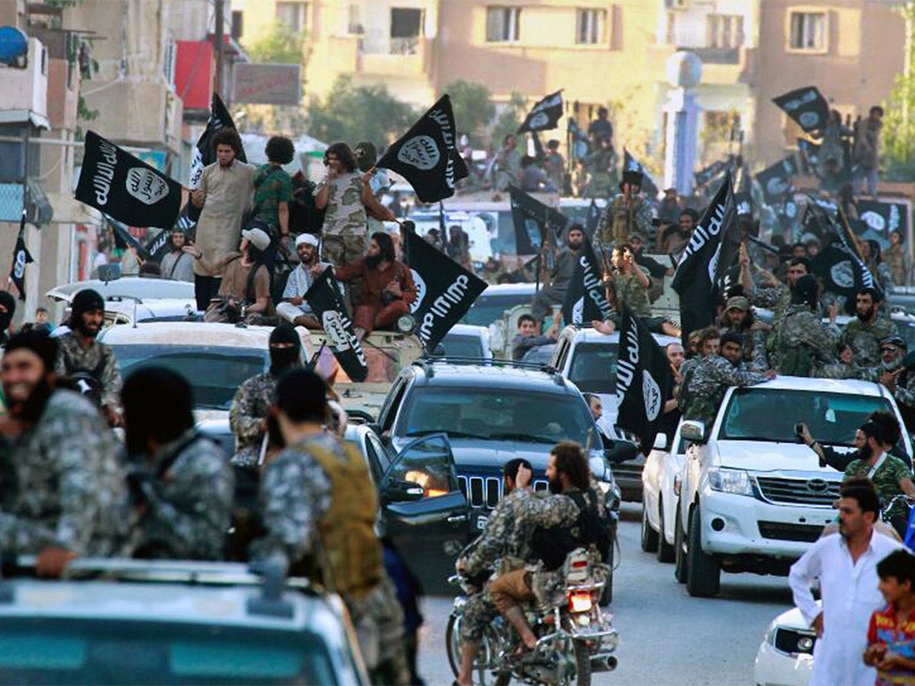 Fighters from Isis parading in Raqqa, northern Syria, where the ‘Islamic State’ has its capital