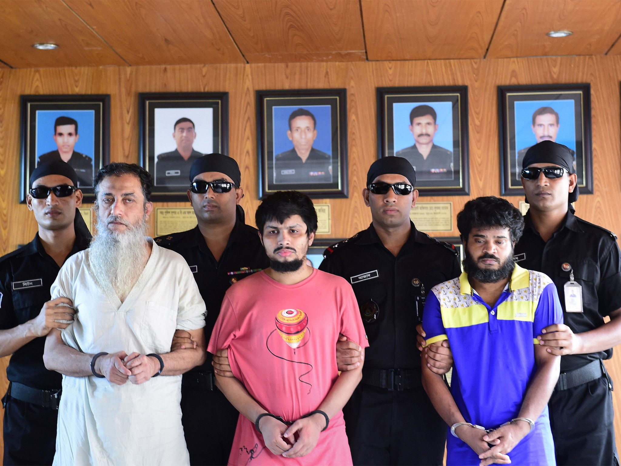 Bangladeshi police officers with Touhidur Rahman, (front left), Sadek Ali (centre) and Aminul Mollick (right)