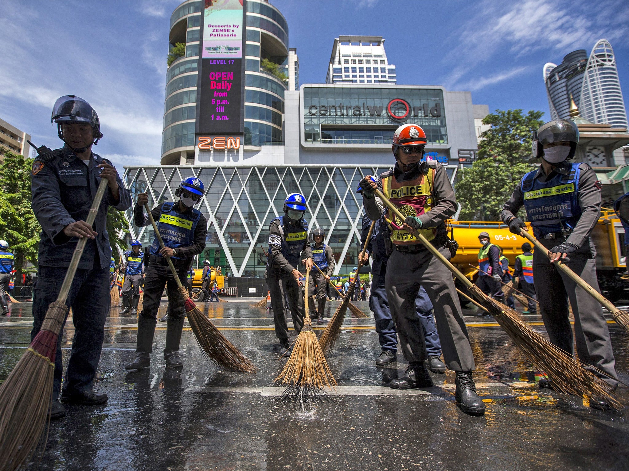 Police officers cleaning the street near the scene of the attack