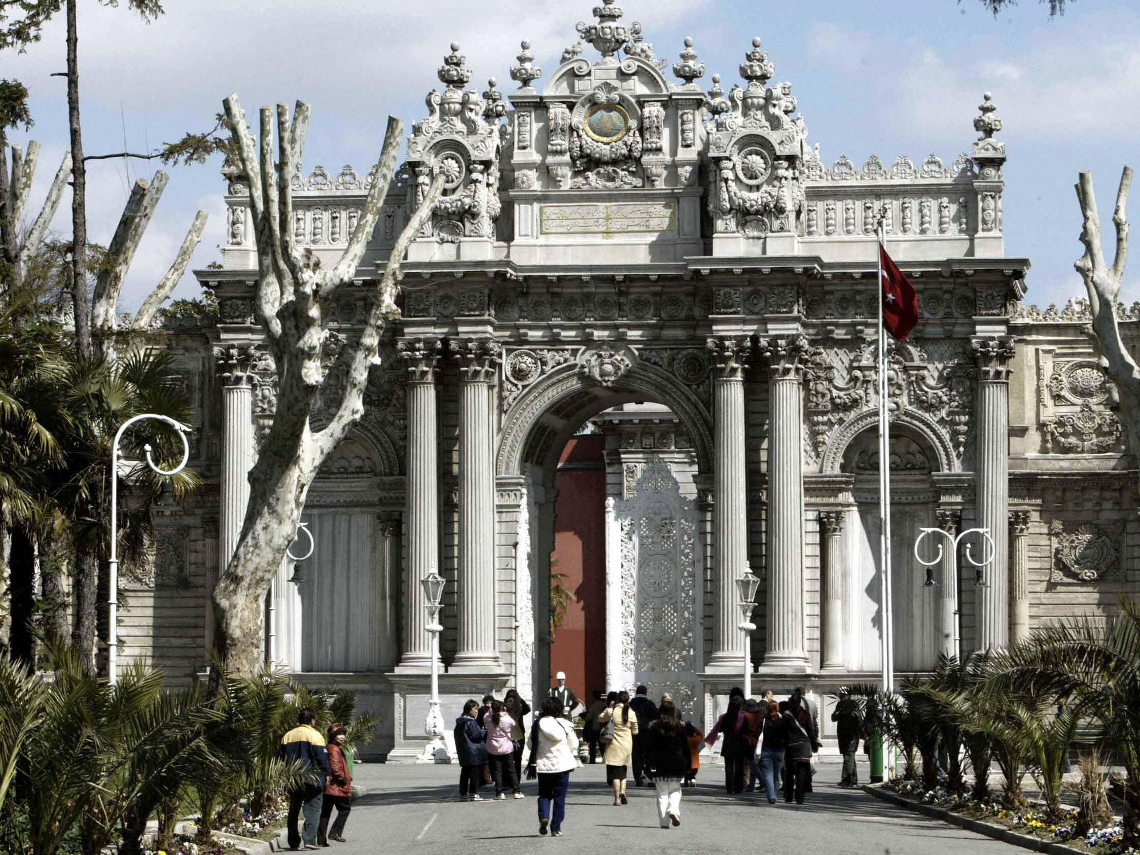 Tourists enter Dolmabahce palace, one of the most lavish Ottoman palaces