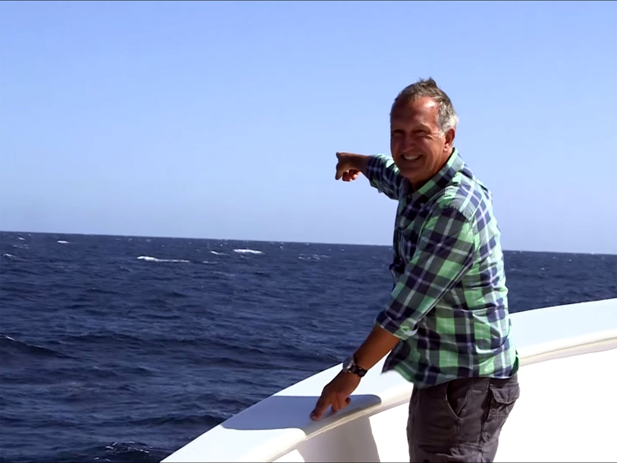 Zoologist Mark Carwardine points at the whale