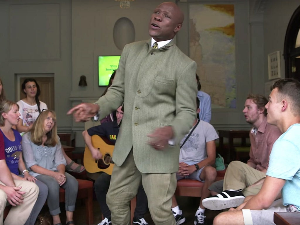 The former boxing champion enjoys a sing-a-long with hostel residents