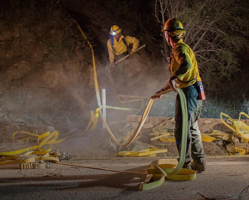 Fires have raged down the West Coast. Pictured: firefighters tackle the blast in California
