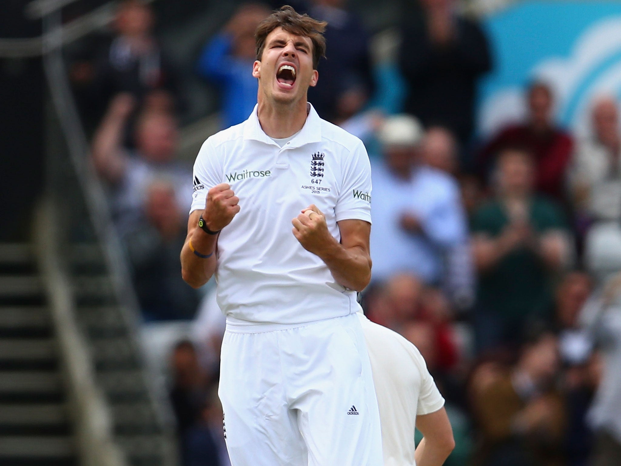 Steve Finn celebrates taking the wicket of Mitch Marsh