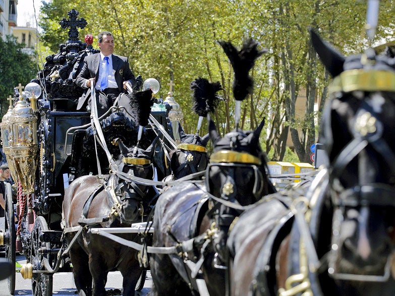 Ornamental black horses carry Casamonica's coffin to the ceremony