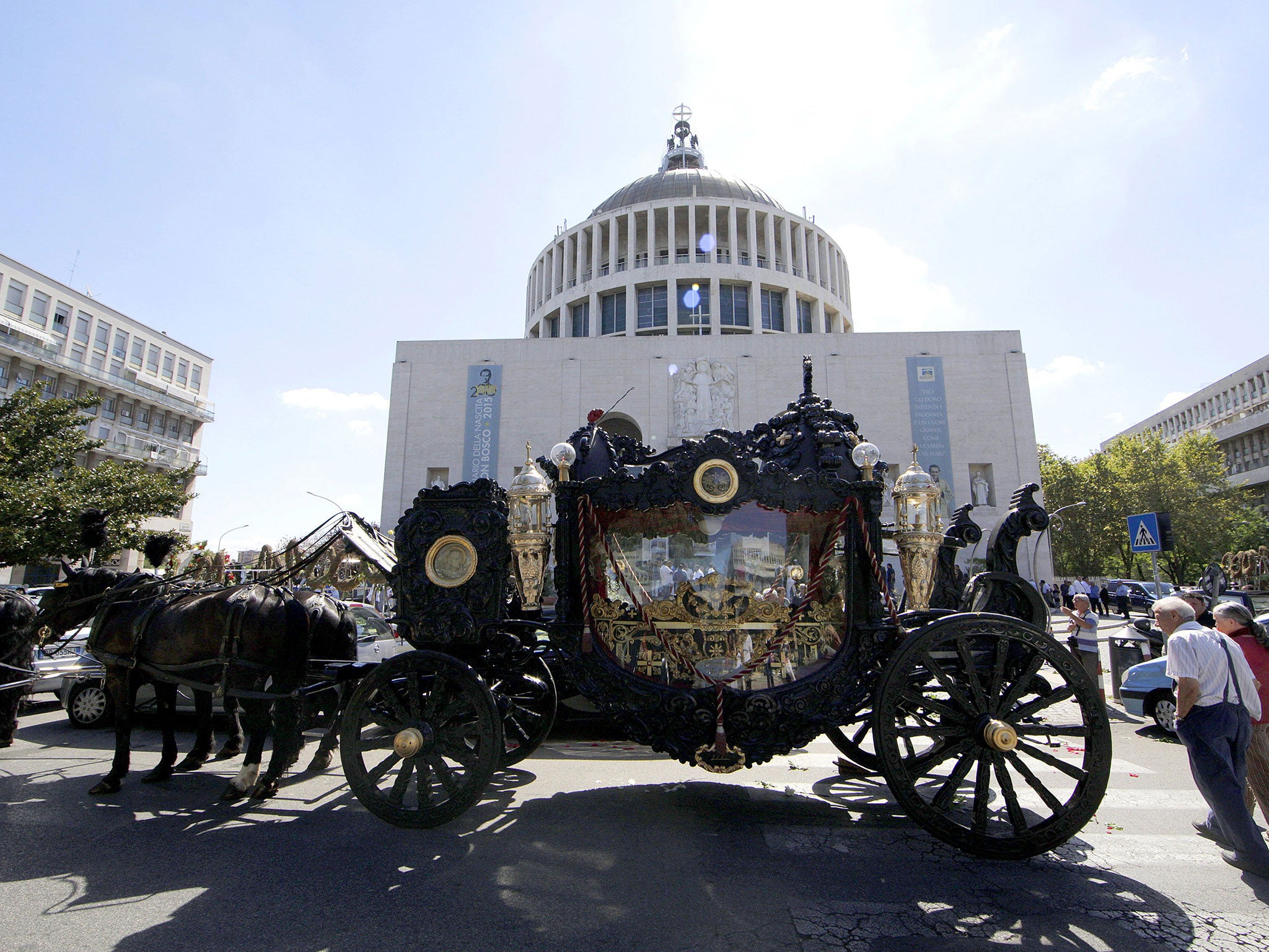 The horse-drawn hearse outside the Don Bosco parish church