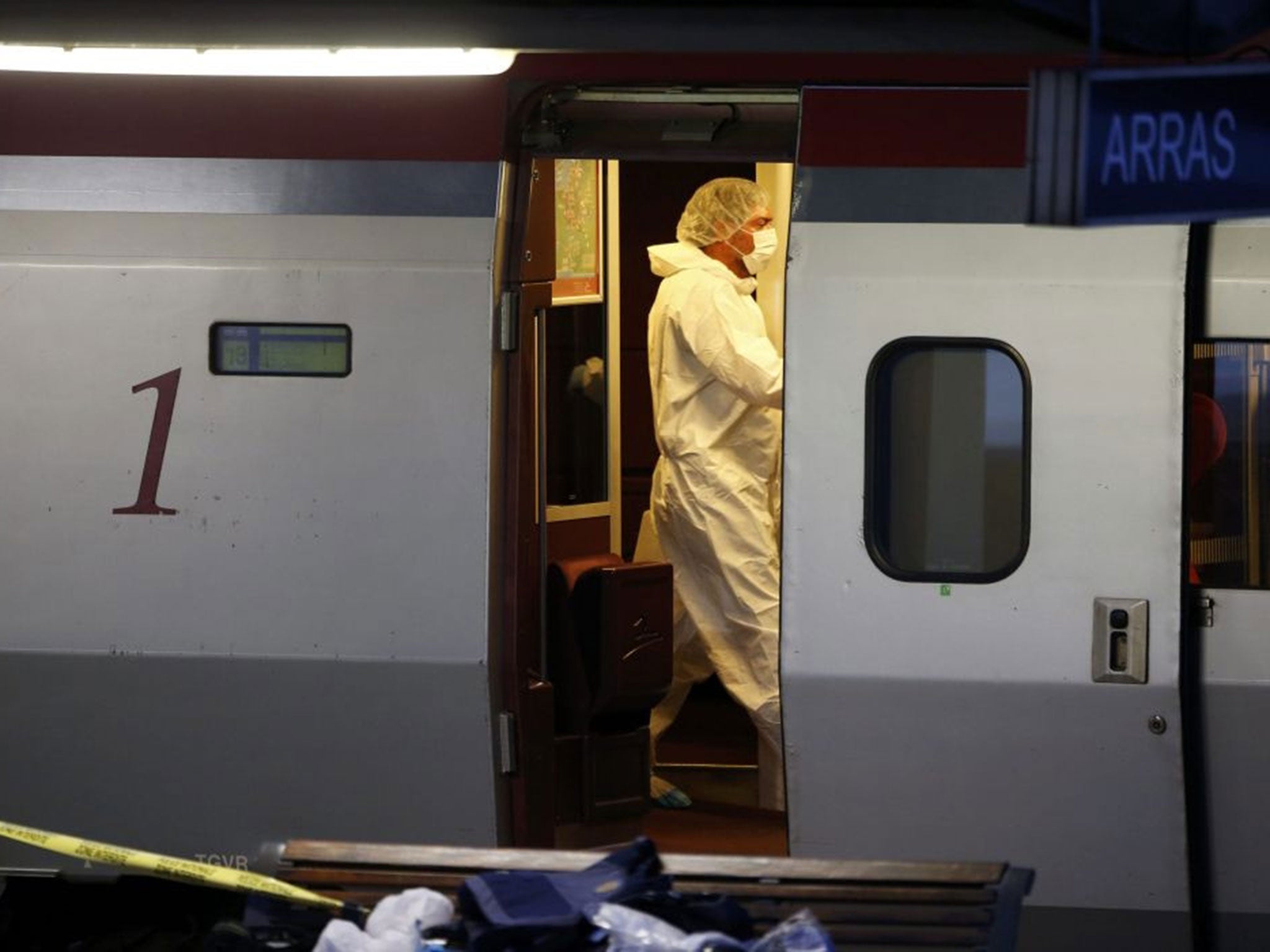 French investigating police in protective clothing collect clues inside the Thalys high-speed train where shots were fired in Arras, France, August 21, 2015. Shots were fired on a Thalys high-speed train between Amsterdam and Paris on Friday and several p