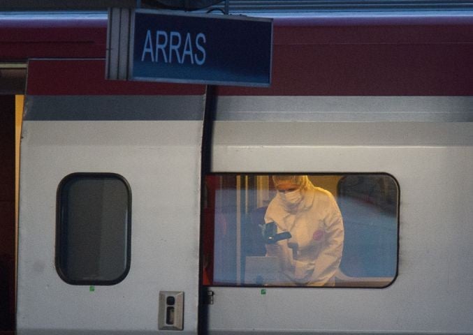 A police investigator videos the crime scene inside the train where the incident occurred