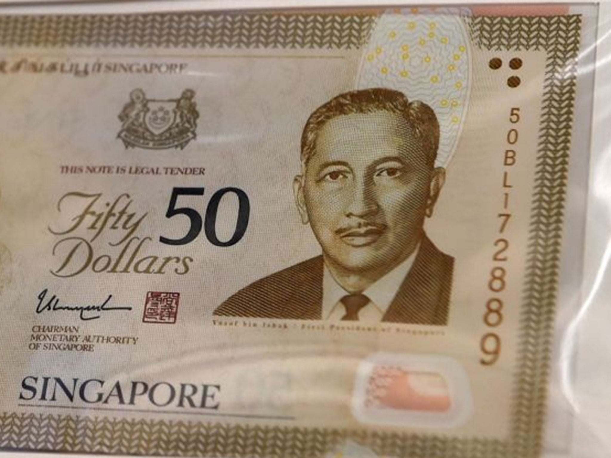 Singapore's central bank has apologised for misspelling the name of the city-state's first president on the packaging of a special currency issue marking the country's 50th year of independence.