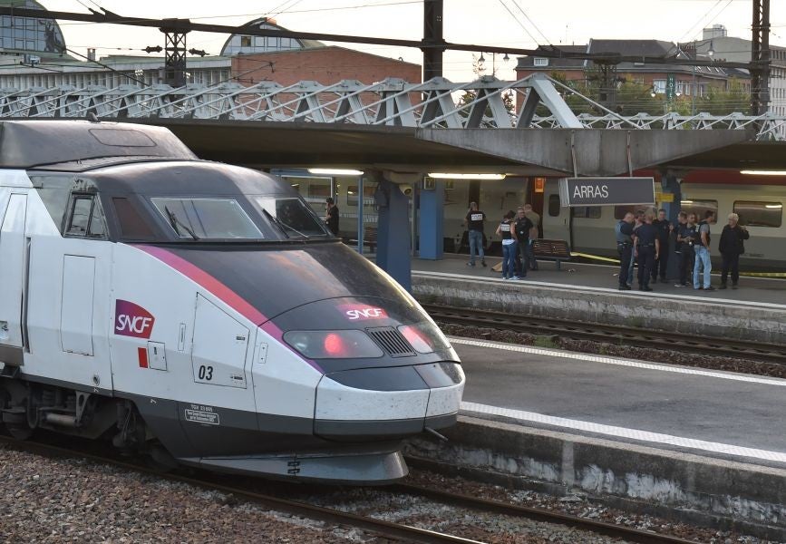 Investigators gather by the Thalys train in Arras station (AFP)