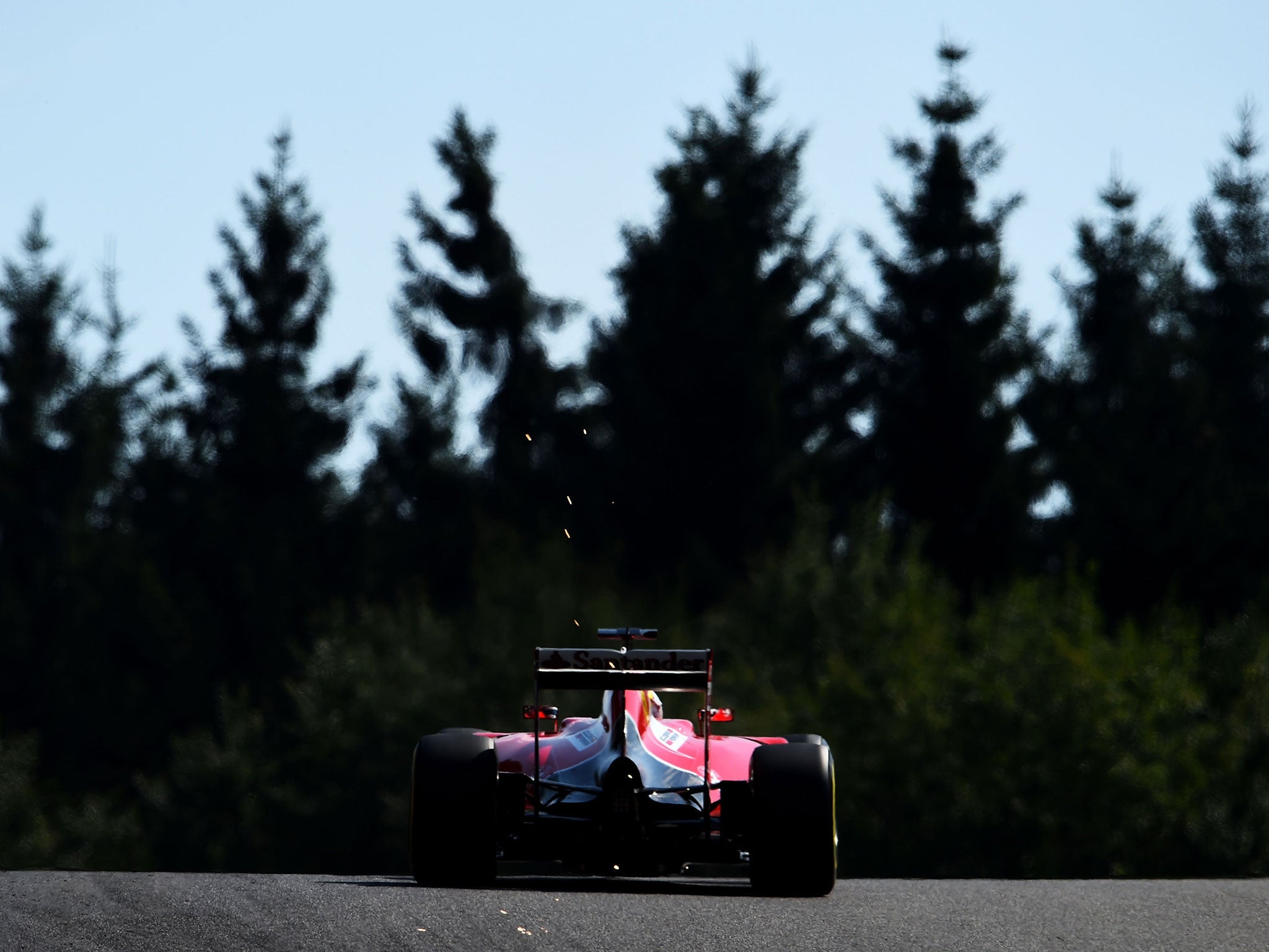 Sebastian Vettel rises over to crest of Eau Rouge