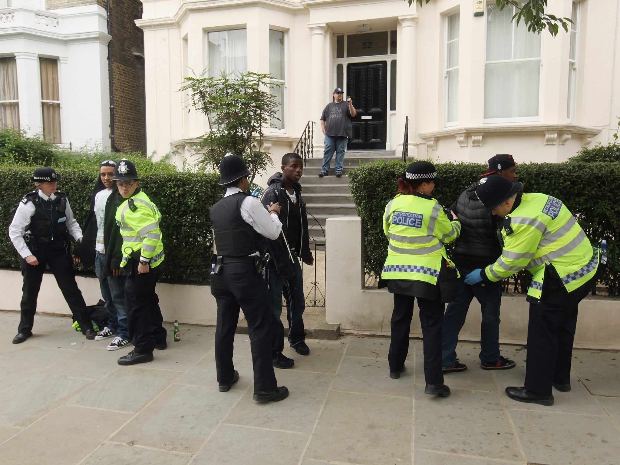 Police officers search young men