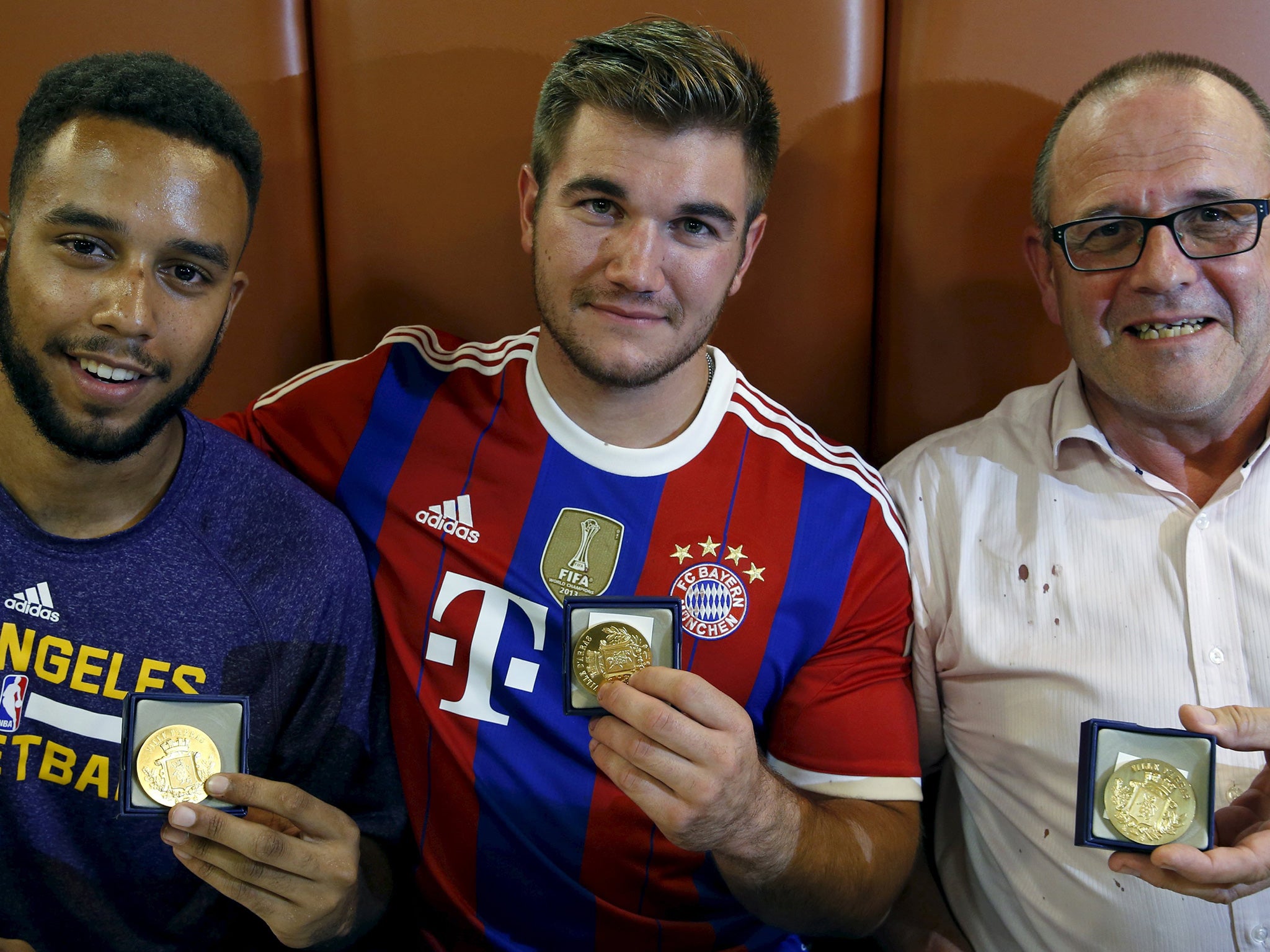 Anthony Sadler, Alek Skarlatos and Chris Norman with medals from the Mayor of Arras