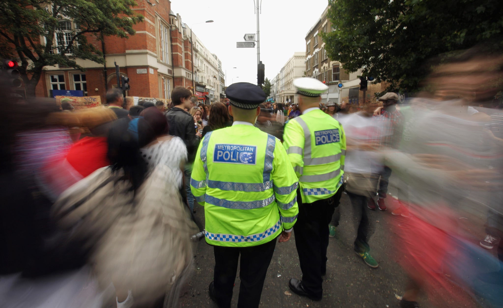 Police officers monitor the crowds at the Notting Hill Carnival on 29 August 2011 in London