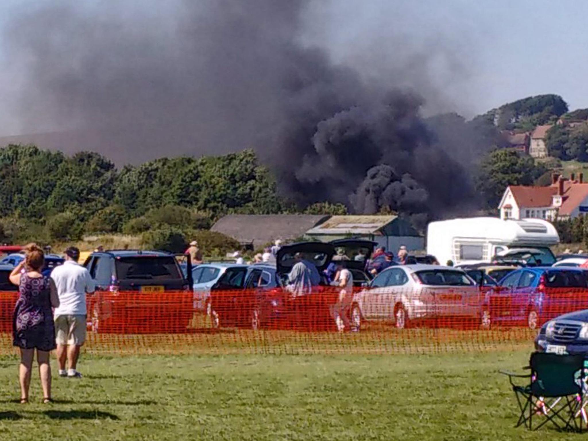 Smoke fills the air after the plane crash (Image: EPA)