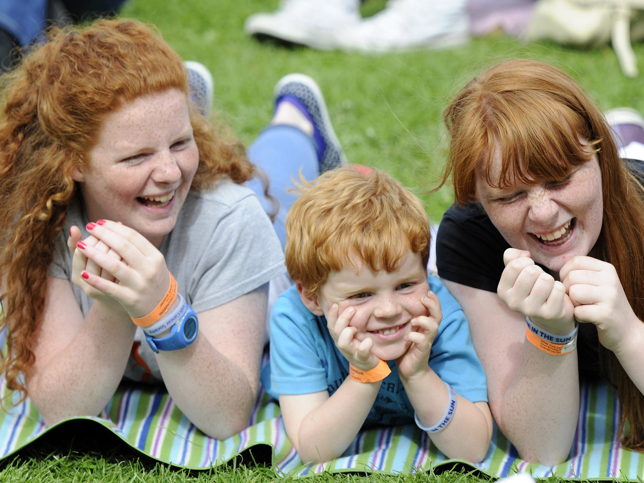 Spectators enjoy the Irish Redhead Convention which celebrates everything to do with red hair held in the village of Crosshaven on August 22, 2015 in Cork, Ireland