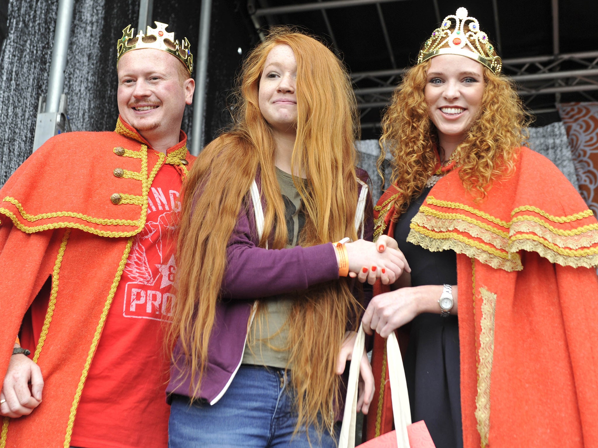 Former Redhead King and Queen, Alan Hayes and Laura May Keohane award the winner of the longest red hair, Nicole Sheehan