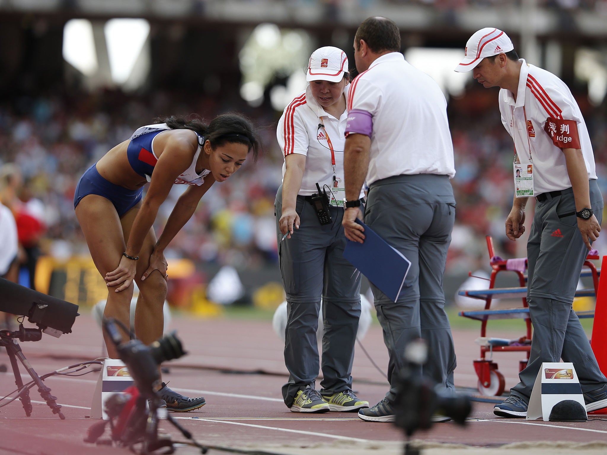 Katarina Johnson-Thompson cuts a forlorn figure following her failure in the long jump which ended her hopes of a medal