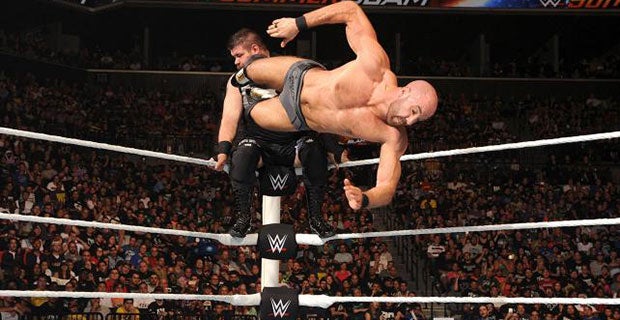 Cesaro dropkicks Kevin Owens on the turnbuckle