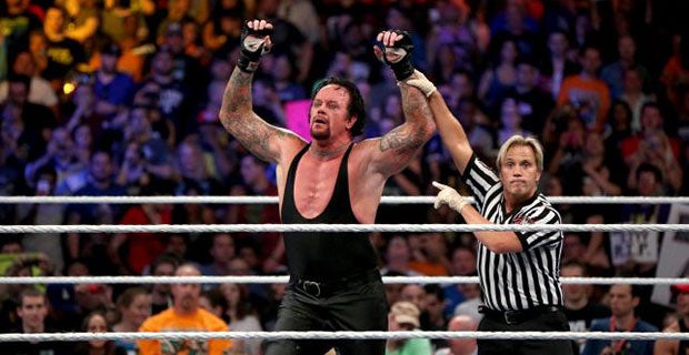 Undertaker celebrates his victory over Lesnar
