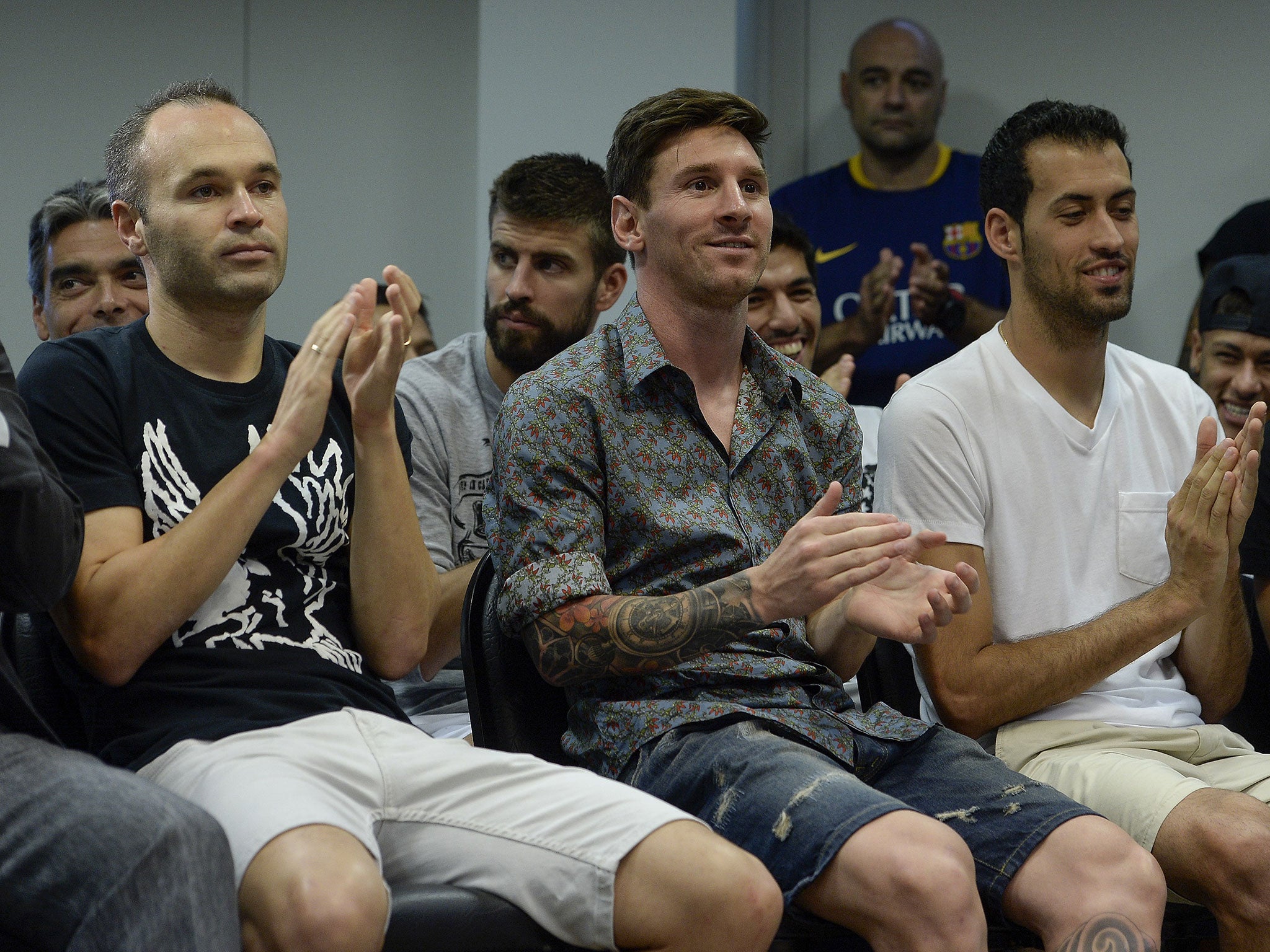 Lionel Messi (C), Barcelona's midfielder Andres Iniesta and midfielder Sergio Busquets at Pedro's farewell