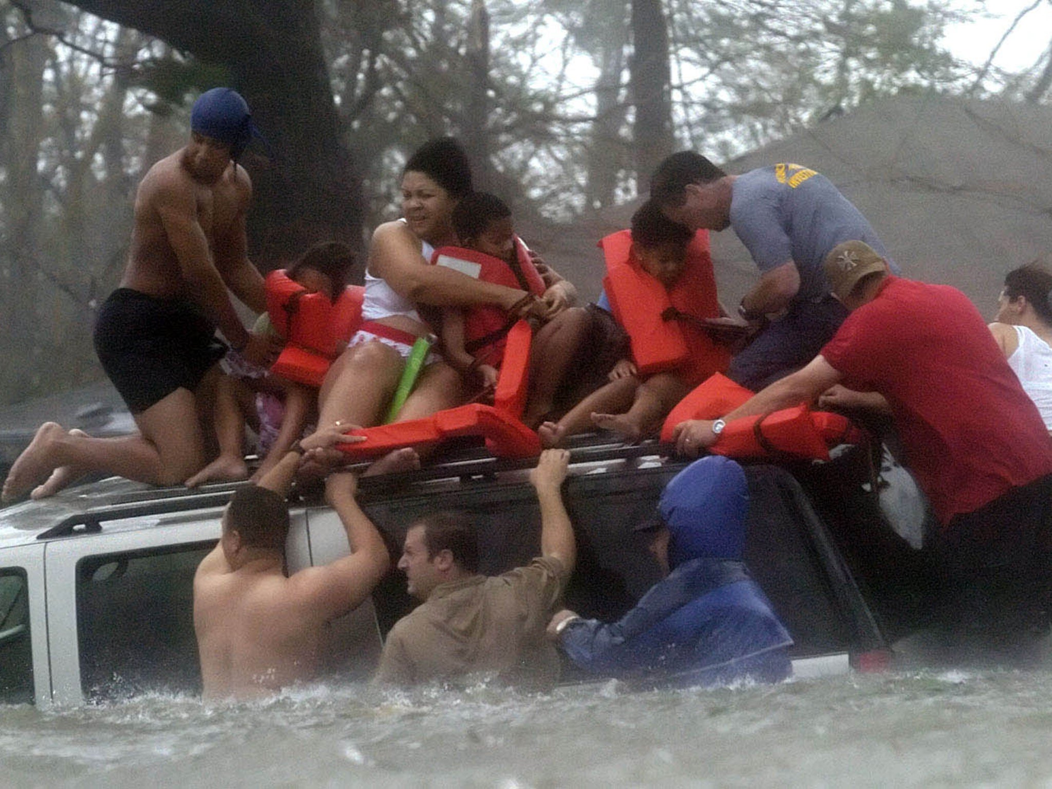 Volunteer crews rescue a family from their home (AP)