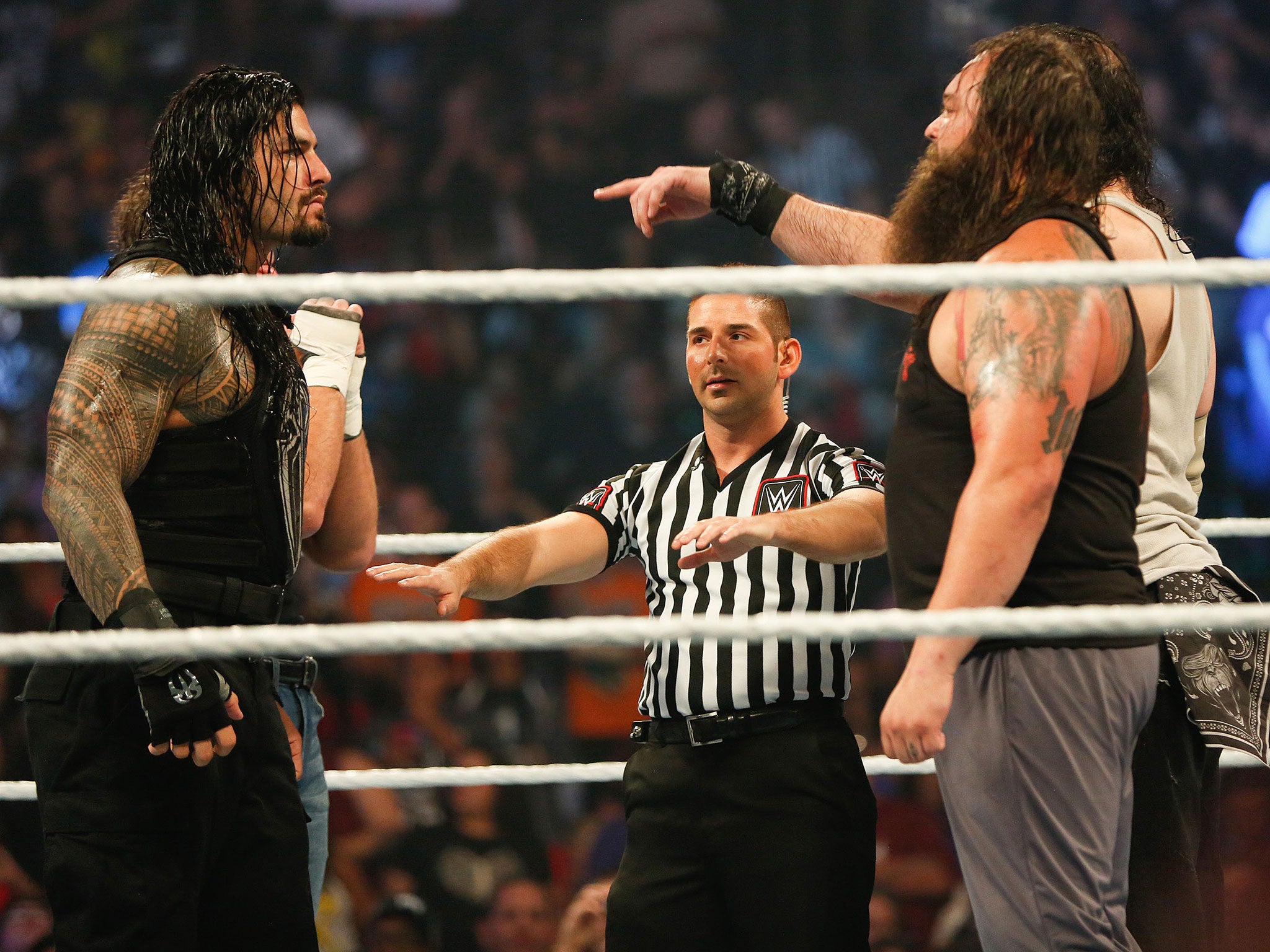 Roman Reigns and Dean Ambrose stare down Bray Wyatt and Luke Harper