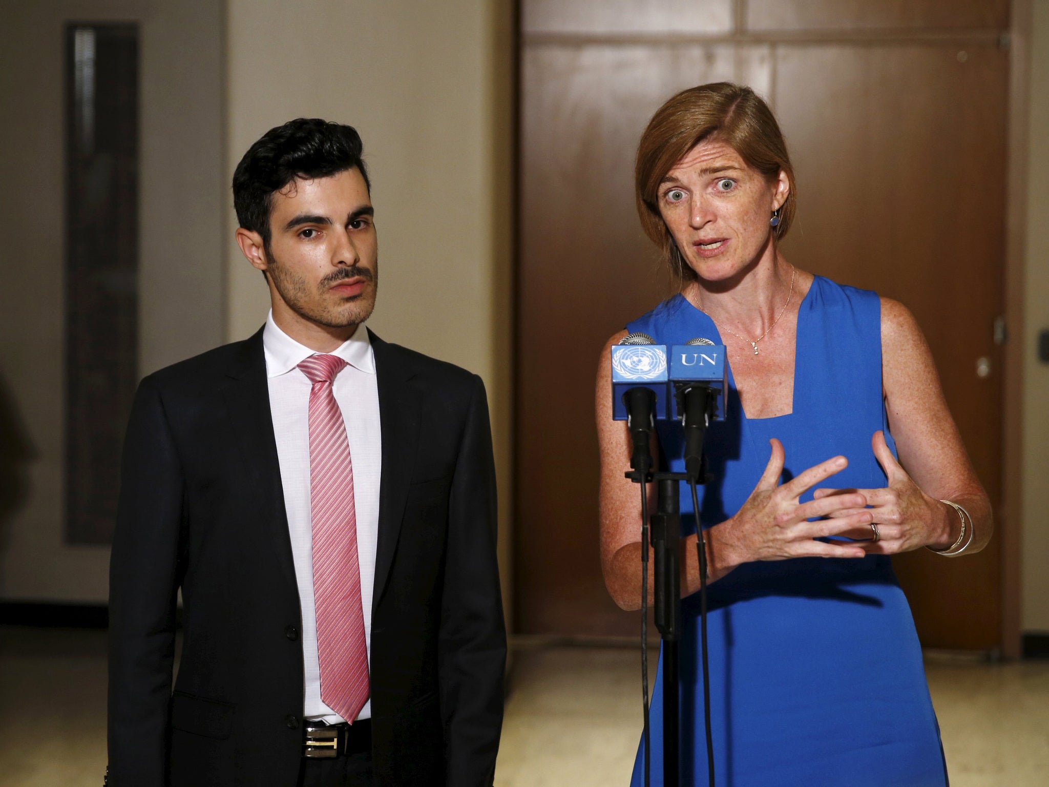 Gay Syrian refugee Subhi Nahas (L) stands with U.S. Ambassador to the United Nations Samantha Power (R) as they speak to the media at the United Nations headquarters in New York