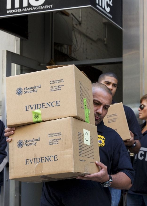 Law enforcement officers seize evidence from the Manhattan offices of Rentboy.com (Image: Reuters)