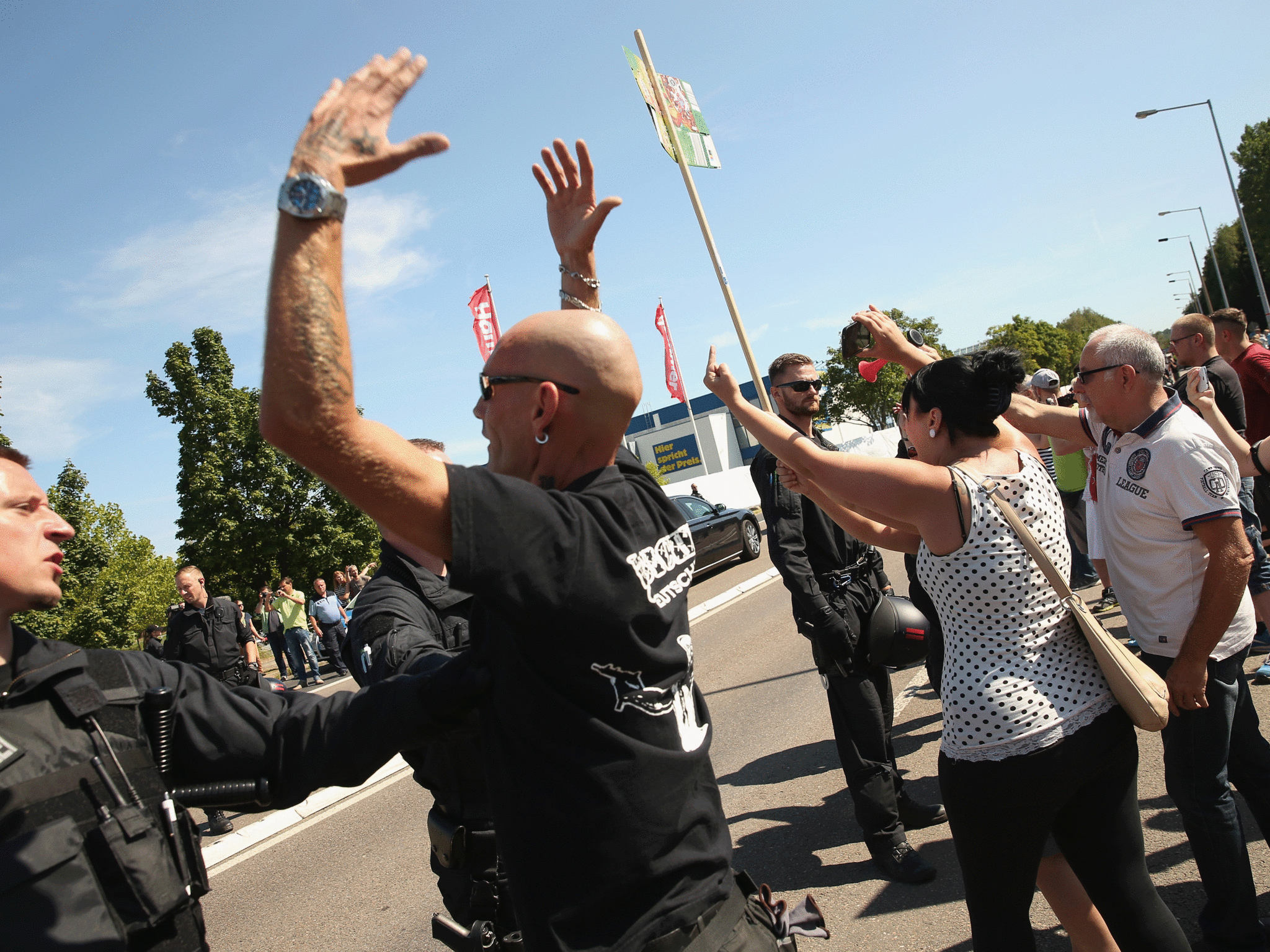 Protestors shout abuse during a visit of Chancellor Angela Merkel to an asylum centre in Heidenau, Germany