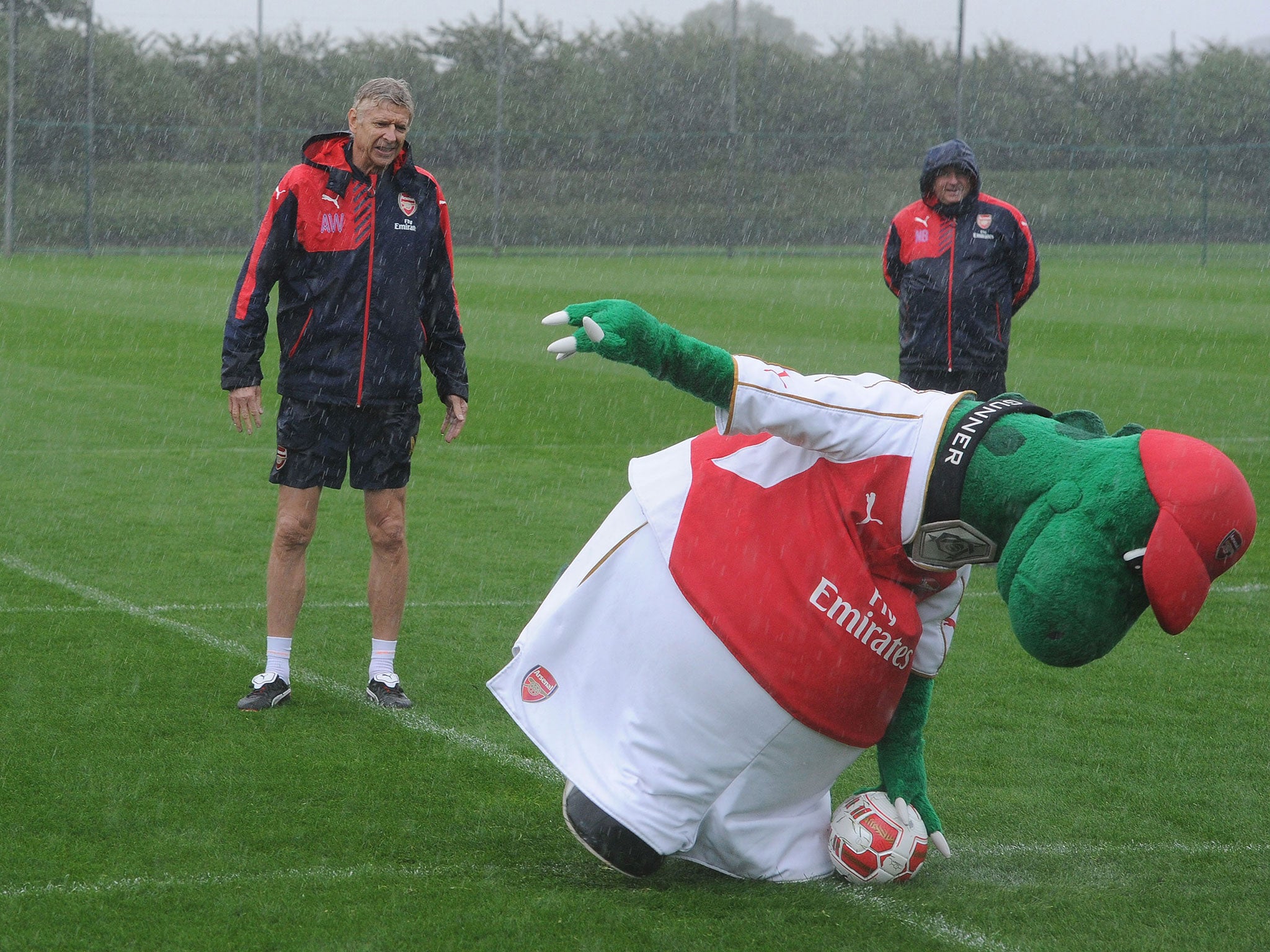 Gunnersaurus begins the task of running around the ball as Wenger watches on