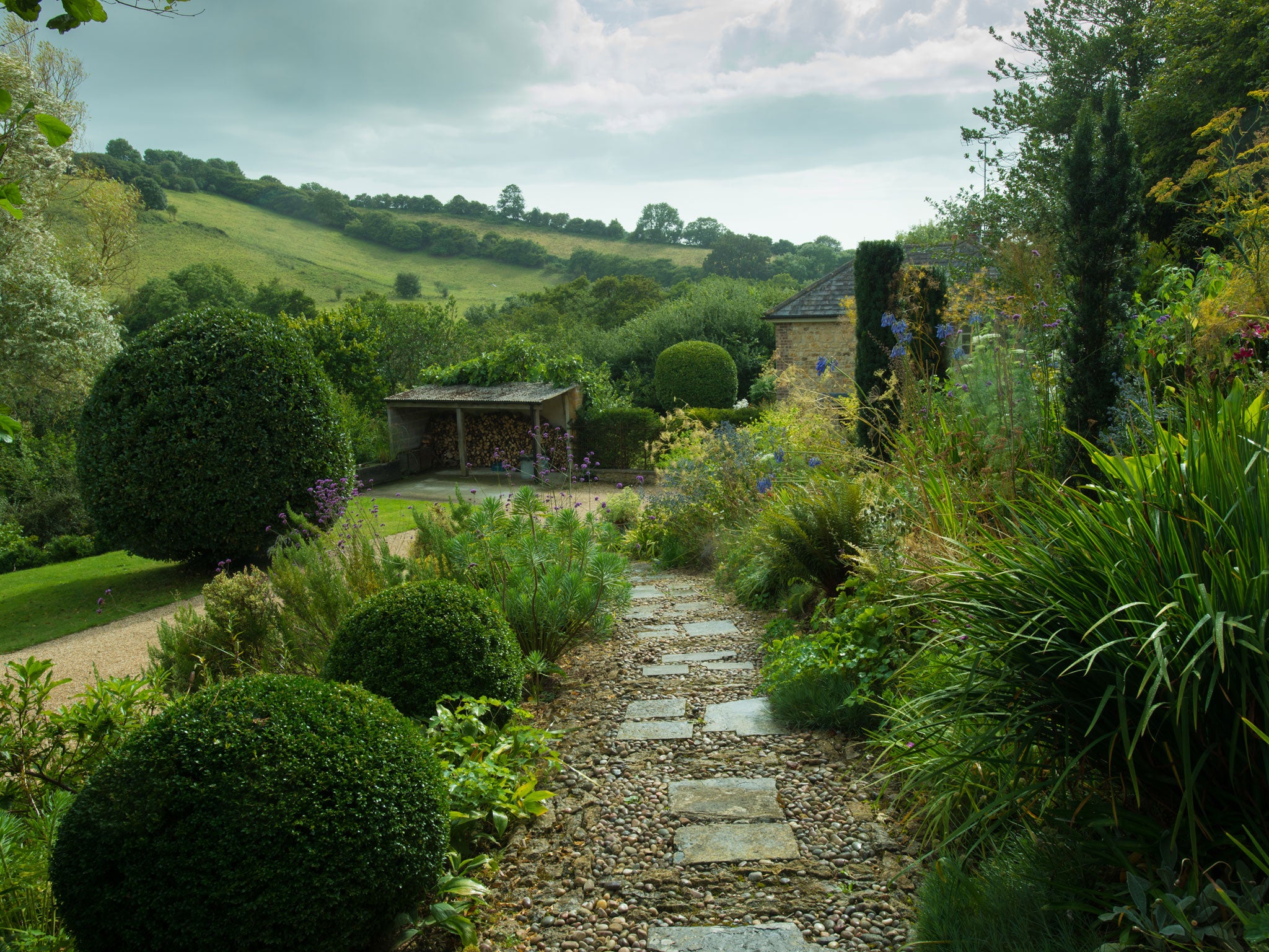 Anna Pavord's garden is a plot of land that she says draws her in and envelops her