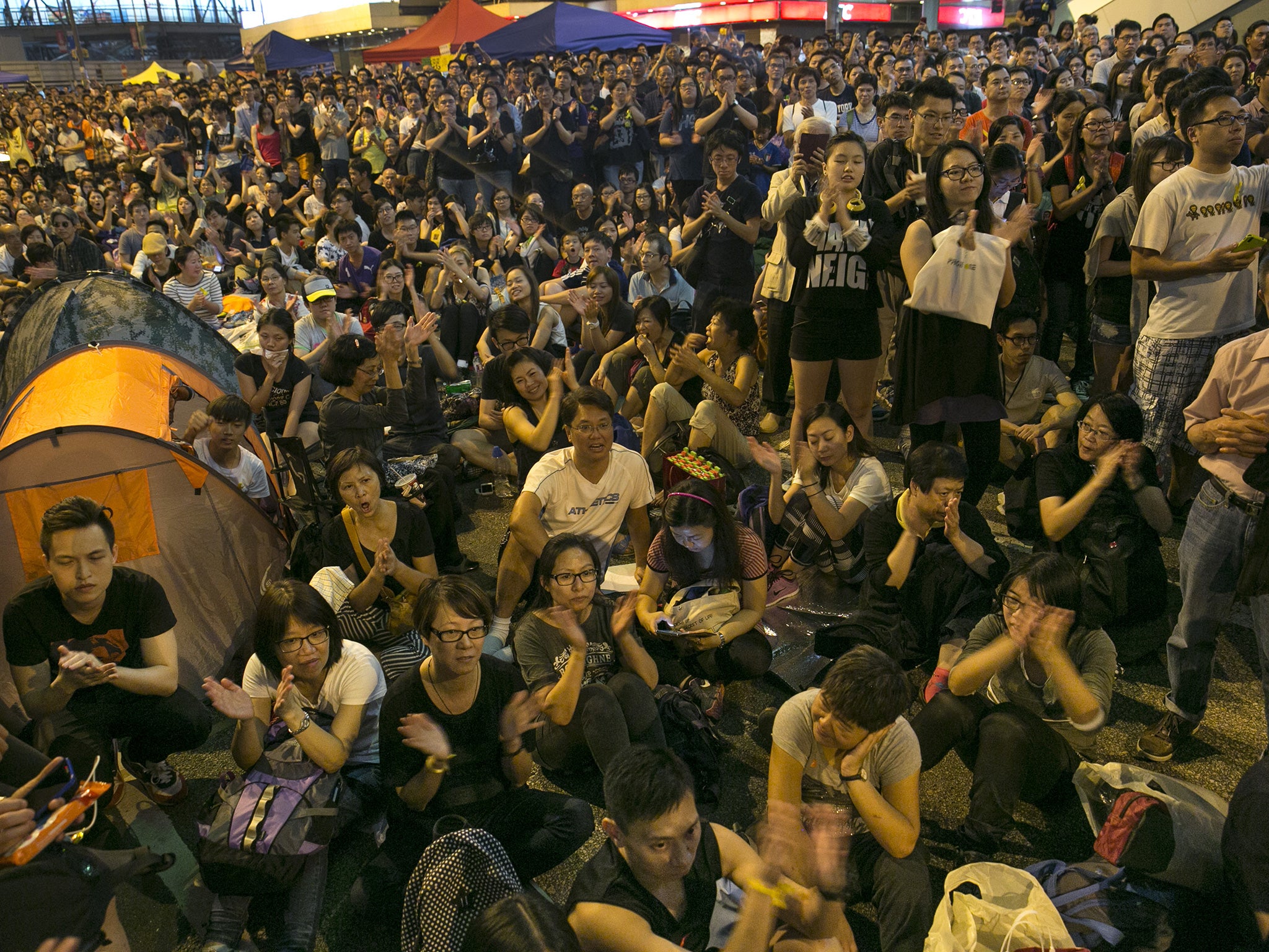 Crowds listen as student leaders Joshua Wong and Alex Chow Yong-Kang speak to a packed crowd at the protest site