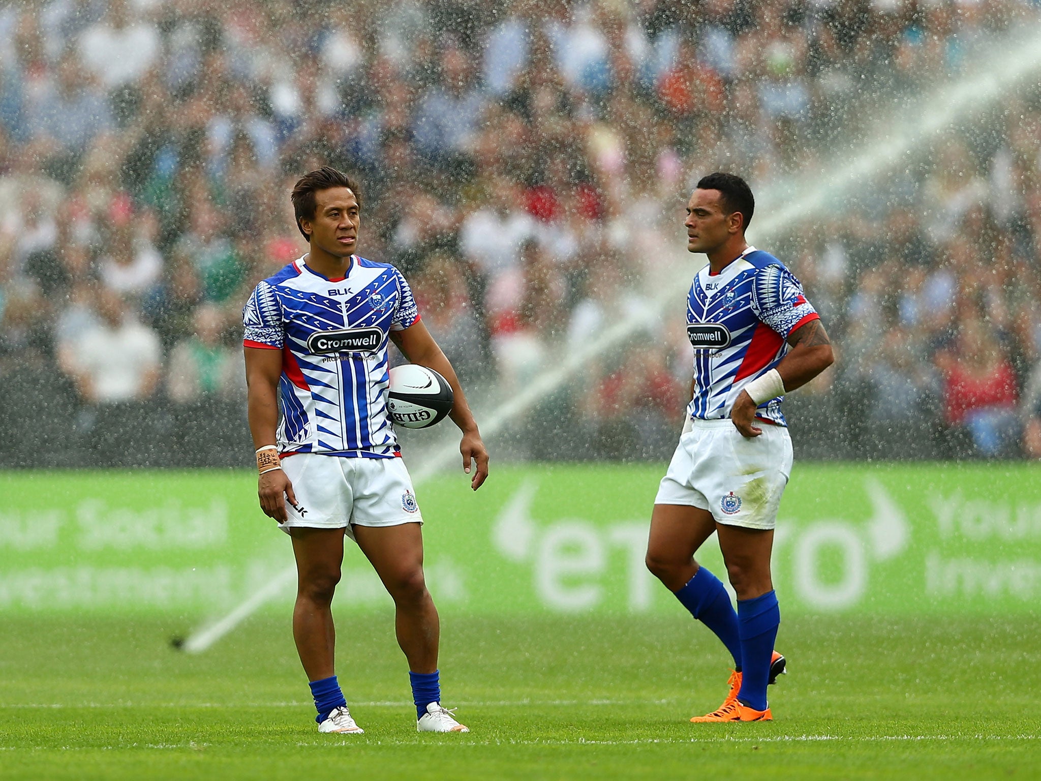 The sprinklers come on during the Barbarians vs Samoa at the Olympic Stadium