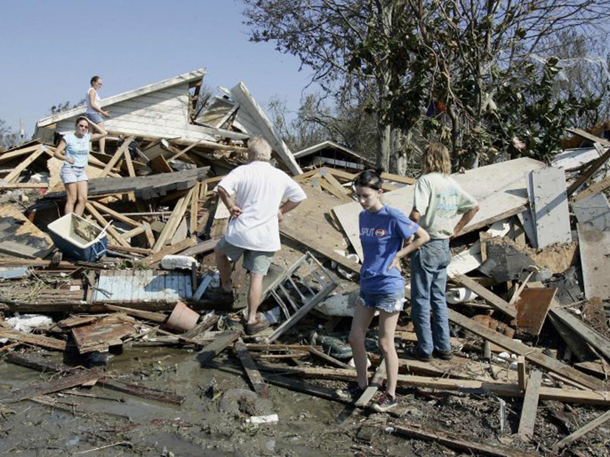 Residents look at their house after it was destroyed by Hurricane Katrina 30 August 2005 (AFP)