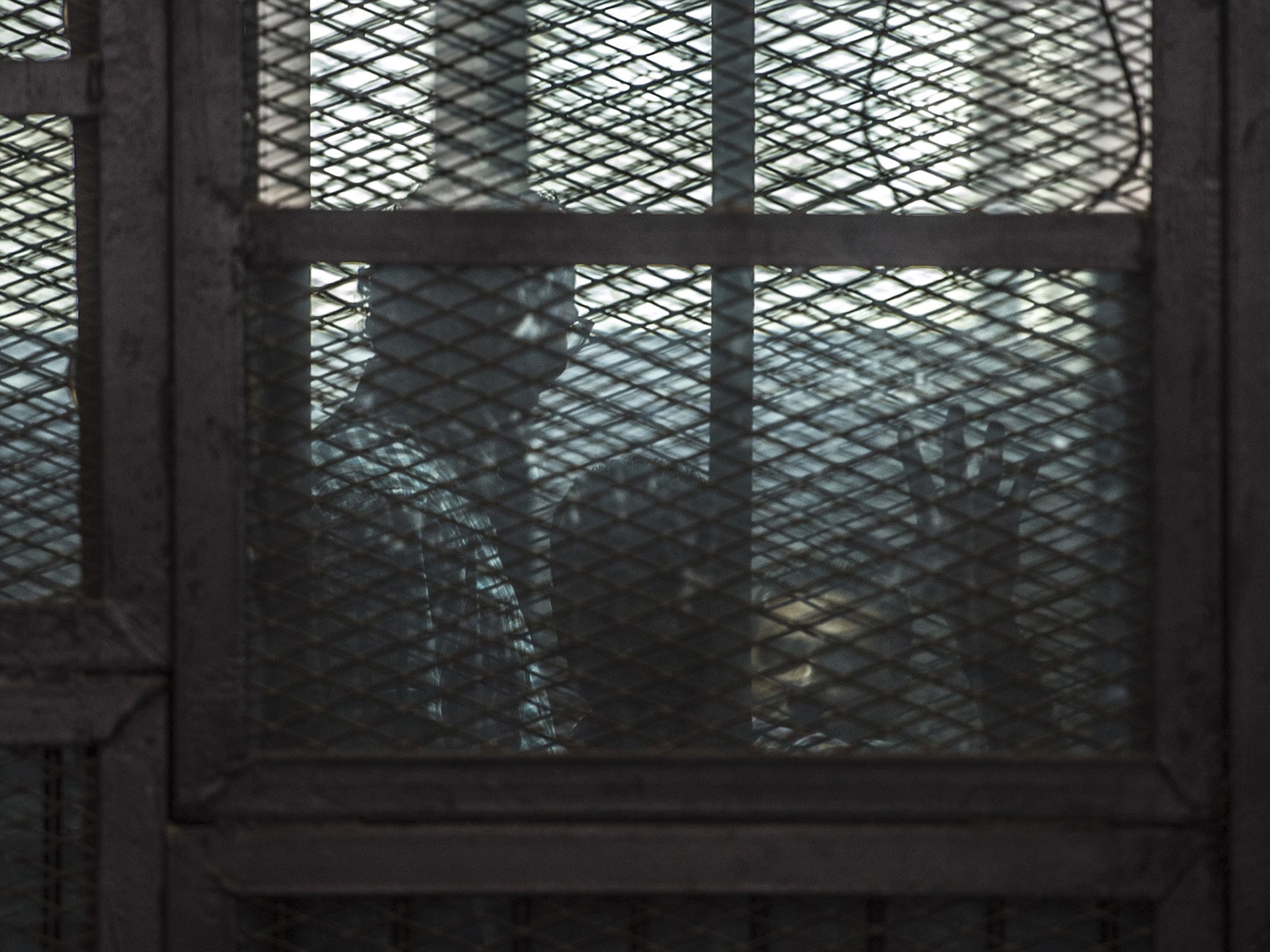 The accused behind glass in court in 2014