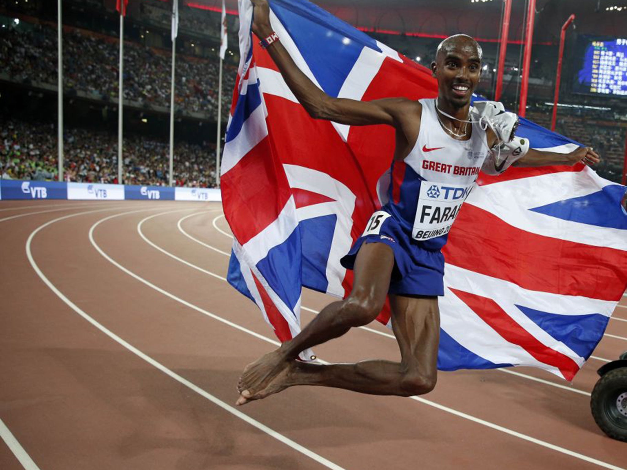 Flying the flag: Mo Farah celebrates his victory in the 5,000m in Beijing