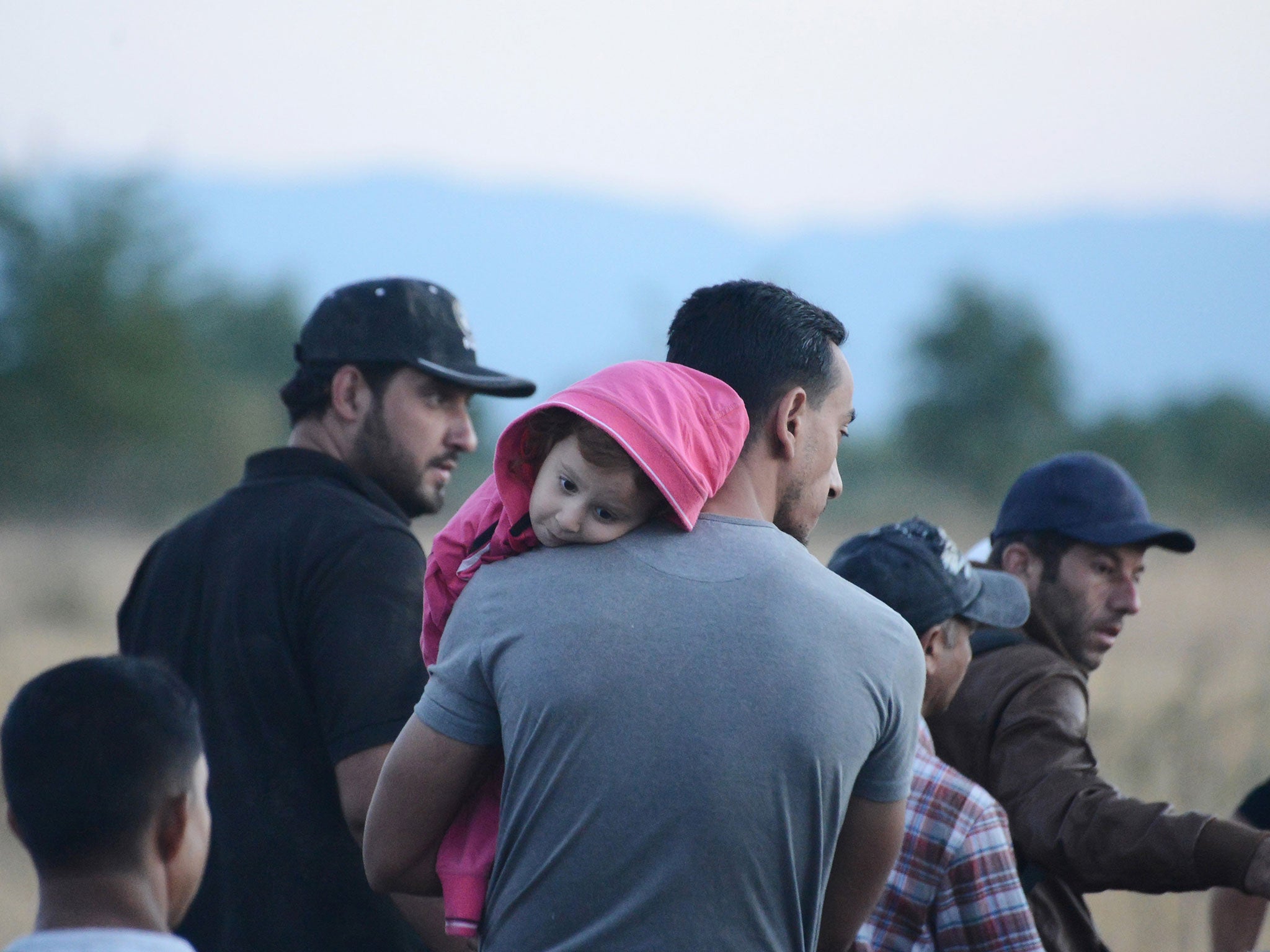 Syrian refugees wait near the Greece-Macedonia border, among tens of thousands hoping to head north to other more prosperous European countries such as Germany, the Netherlands and nations in Scandinavia