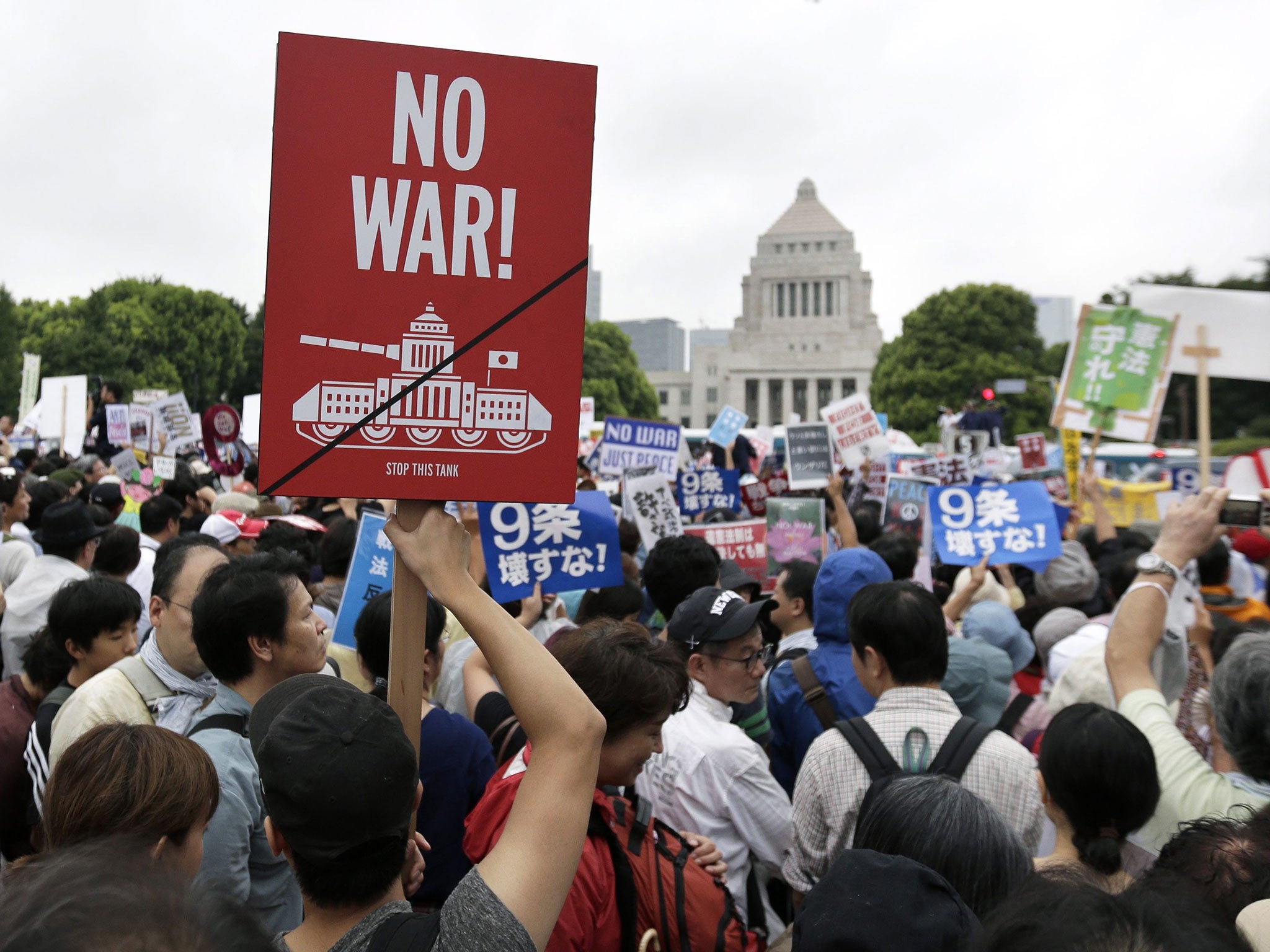 Demonstrators protest against the controversial security bills outside the Japan's parliament building in Tokyo