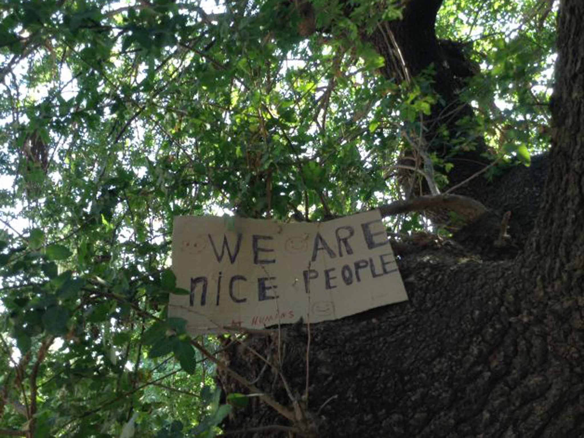 Refugees hang a sign that reminds the world they are human - each day 500-900 have been arriving on the island of Kos