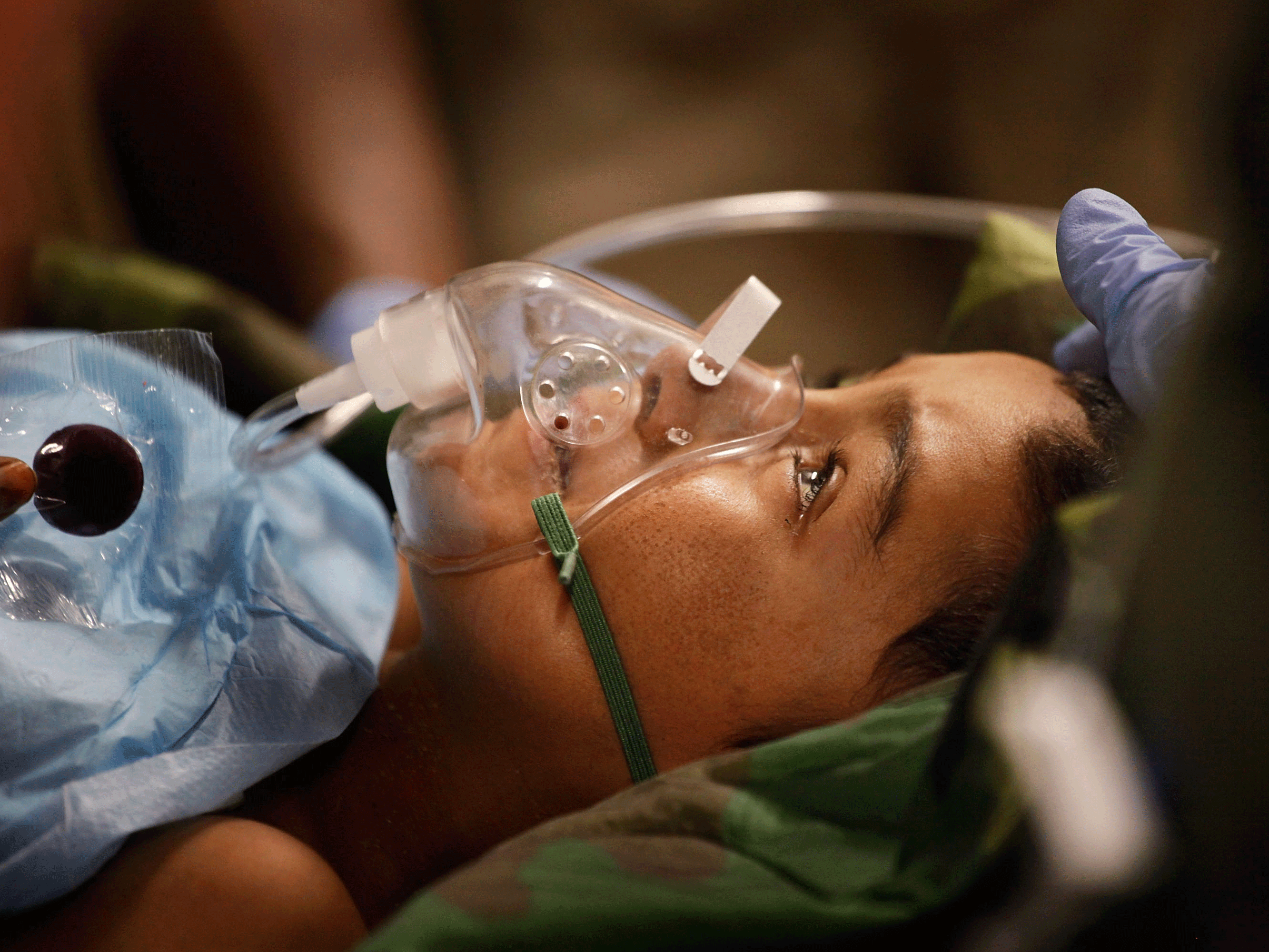 An Afghan boy, his body rigid from Tetanus, is treated in an American military hospital in Helmand Province