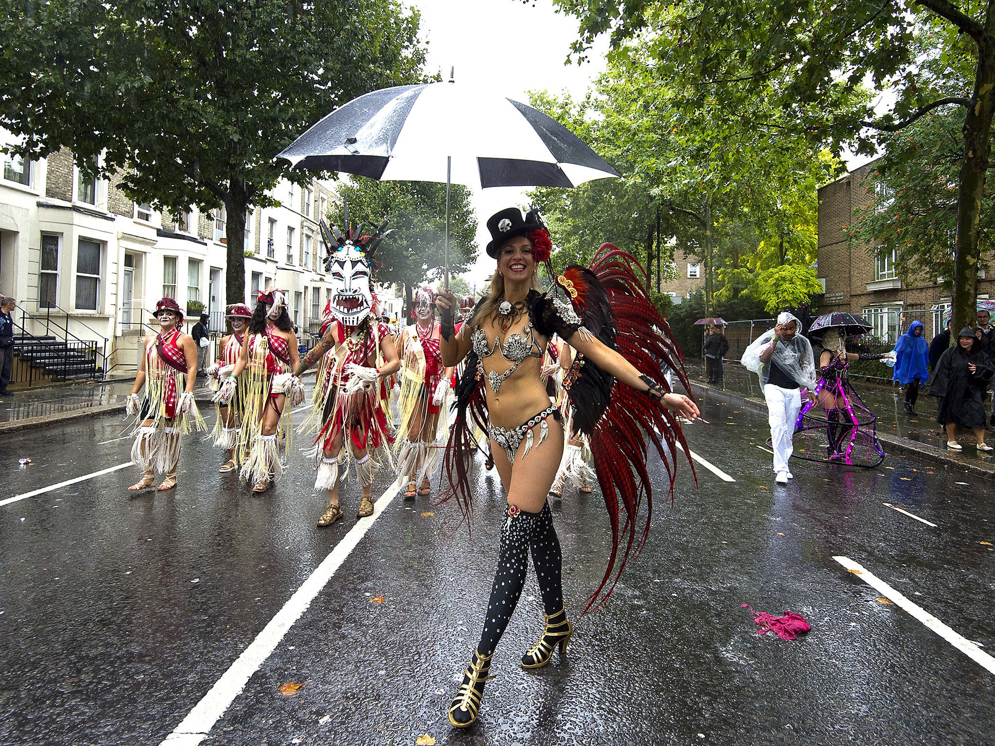 Members of the London Samba School perform in the rain during the parade at Notting Hill Carnival