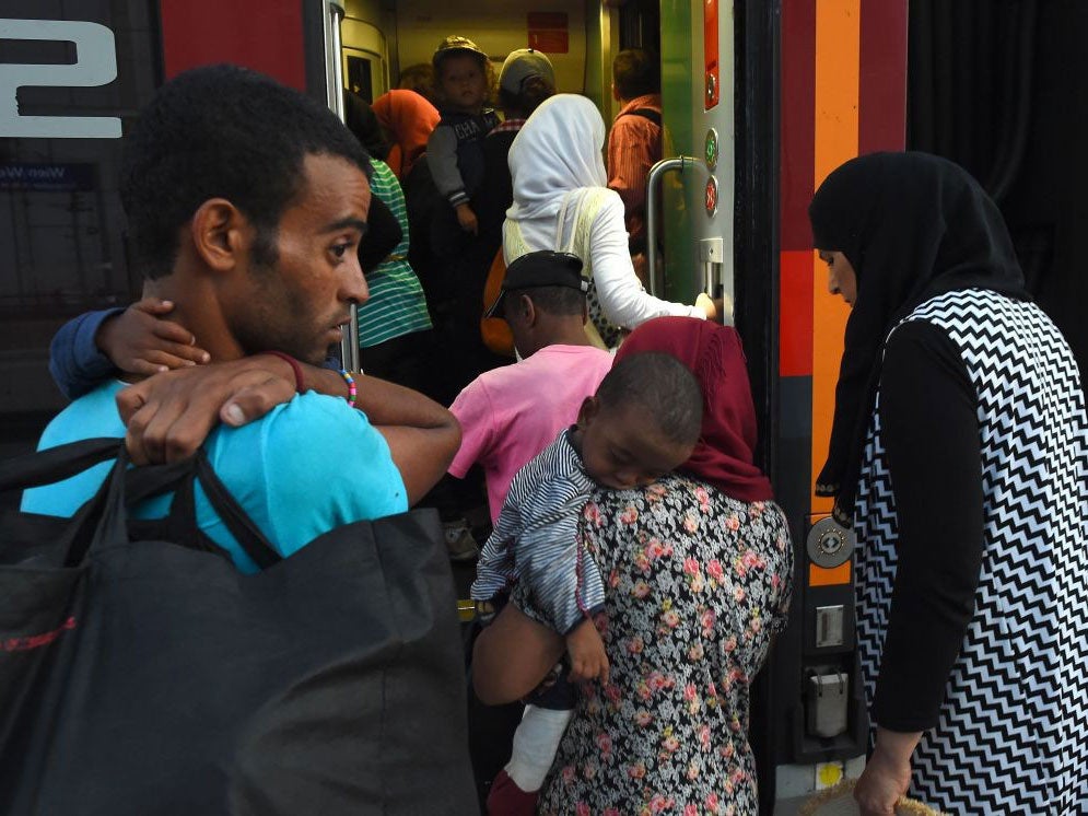 Migrants board a train to Munich at Vienna's Westbahnhof railway station in the early hours of September 1, 2015.