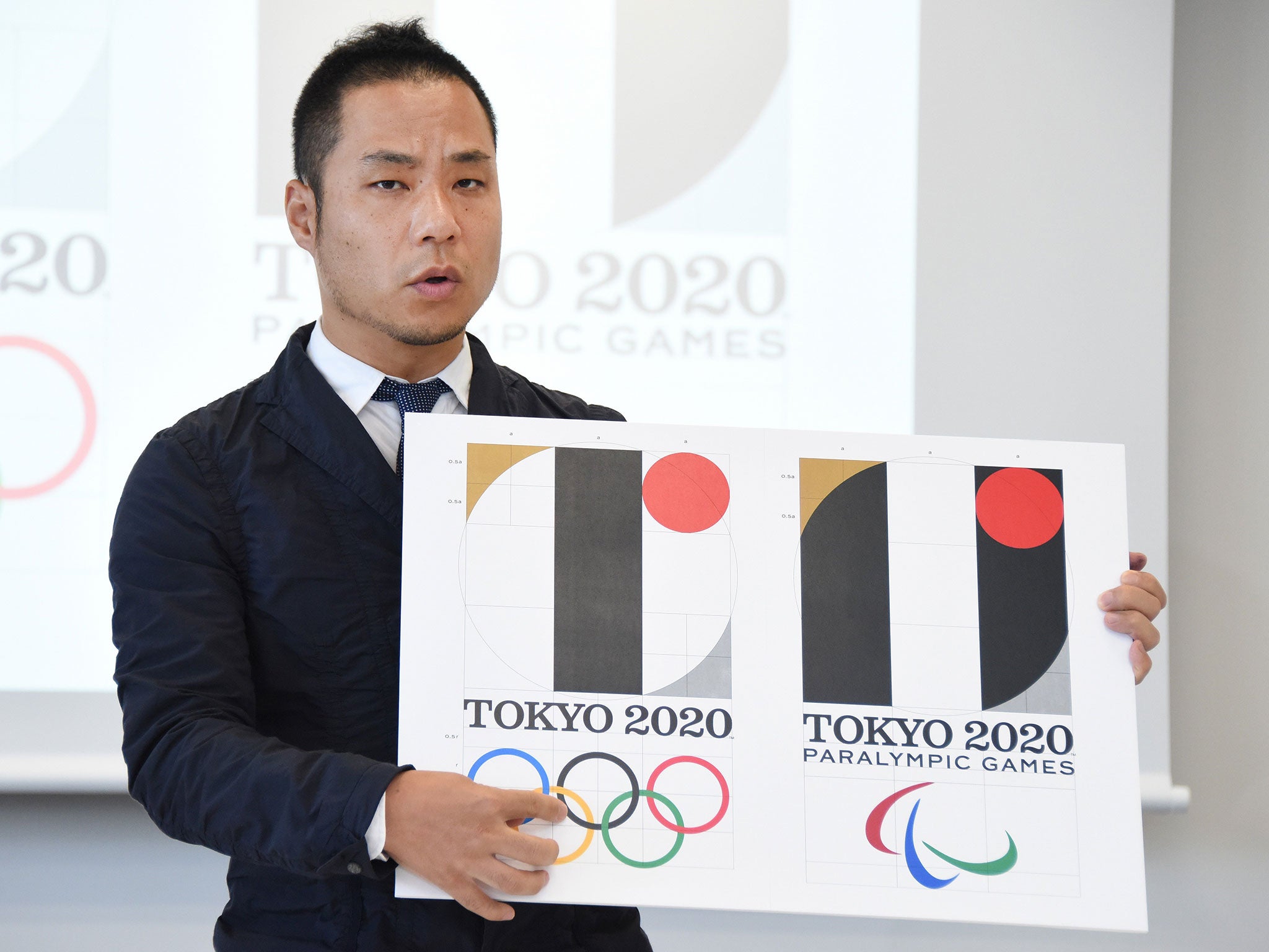 Tokyo Olympic logo designer Kenjiro Sano explains his design during a press conference