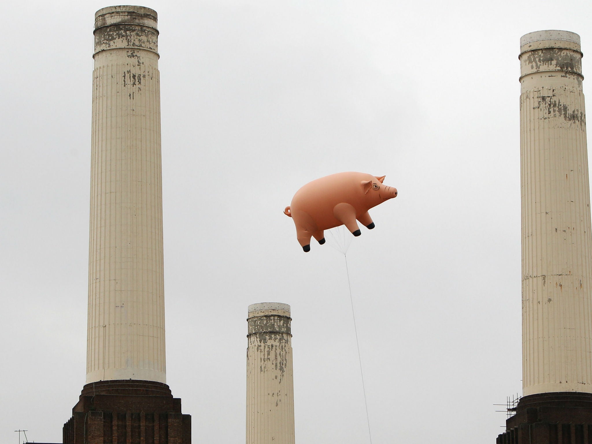 The inflatable pig floats above Battersea Power Station in a recreation of Animals
